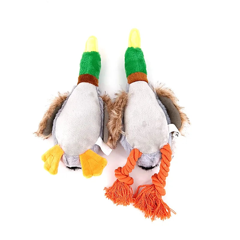 Two plush duck toys with green and orange accents on a white background. One of the ducks has plush feet and the other has rope feet.