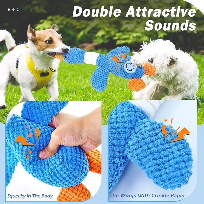 Blue goose dog toy with crinkle paper wings and squeaky sound, shown being played with by two dogs outdoors.